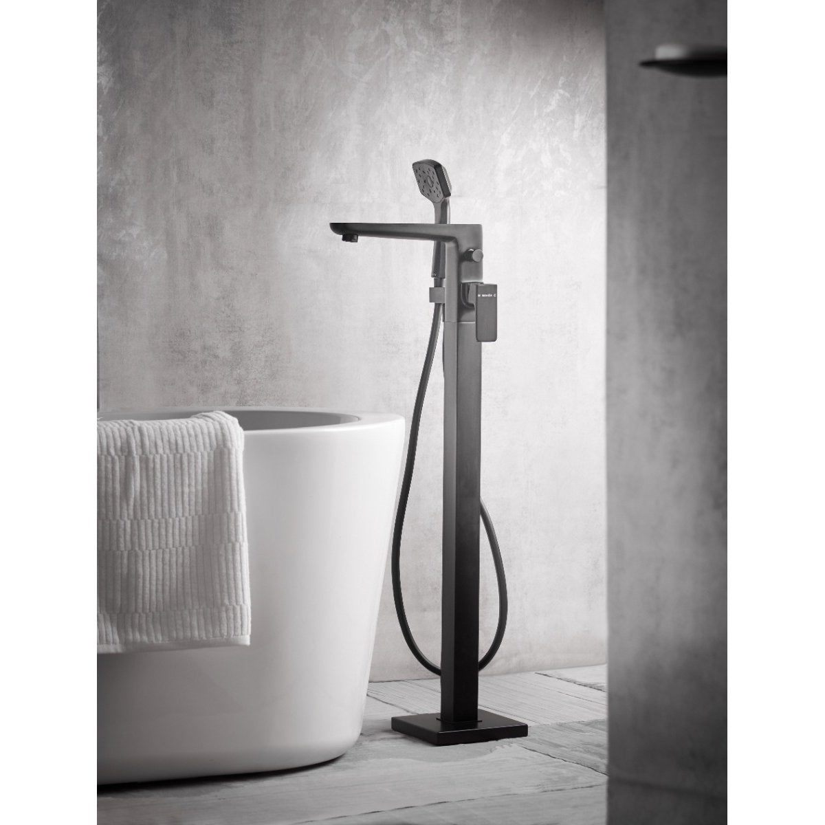 Methven Satinjet Wai floor mounted bath shower mixer in matte black in a bathroom setting